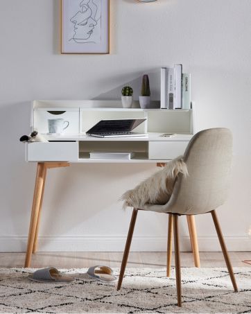 a white desk with plenty of storage and a large surface area sits in a well lit officespace