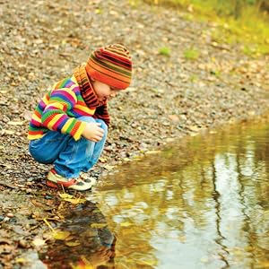 Small child next to pond