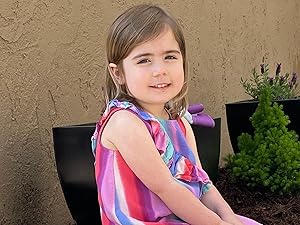 Young child posing next to Mulch & Rock Bond